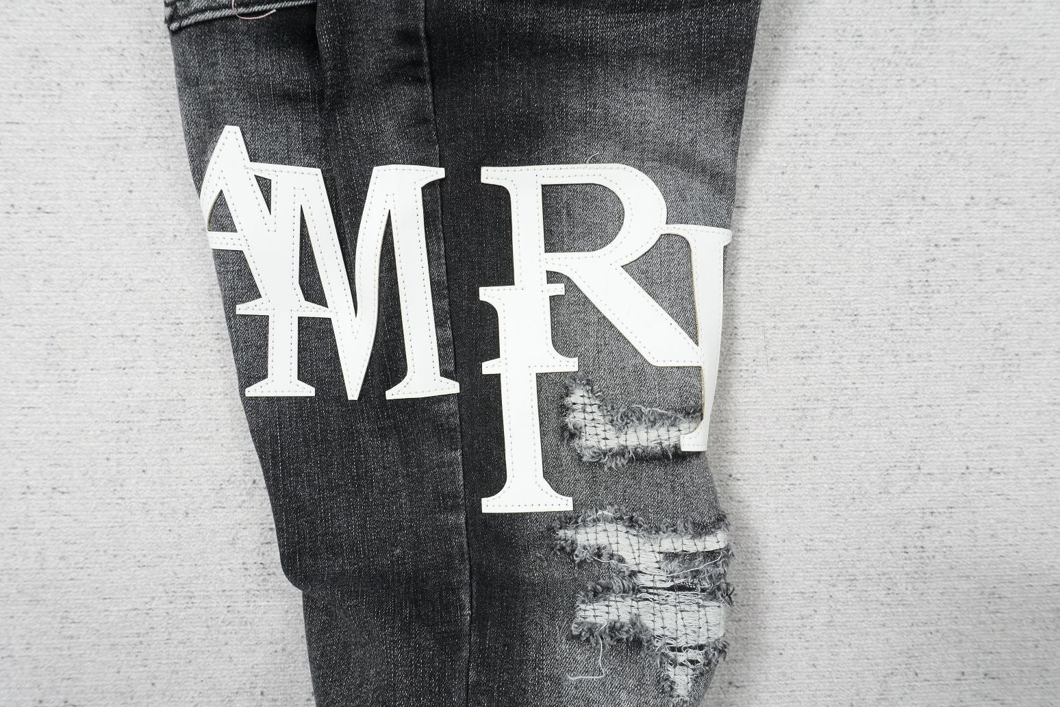 AMIRI BLACK WITH WHITE WRITTING