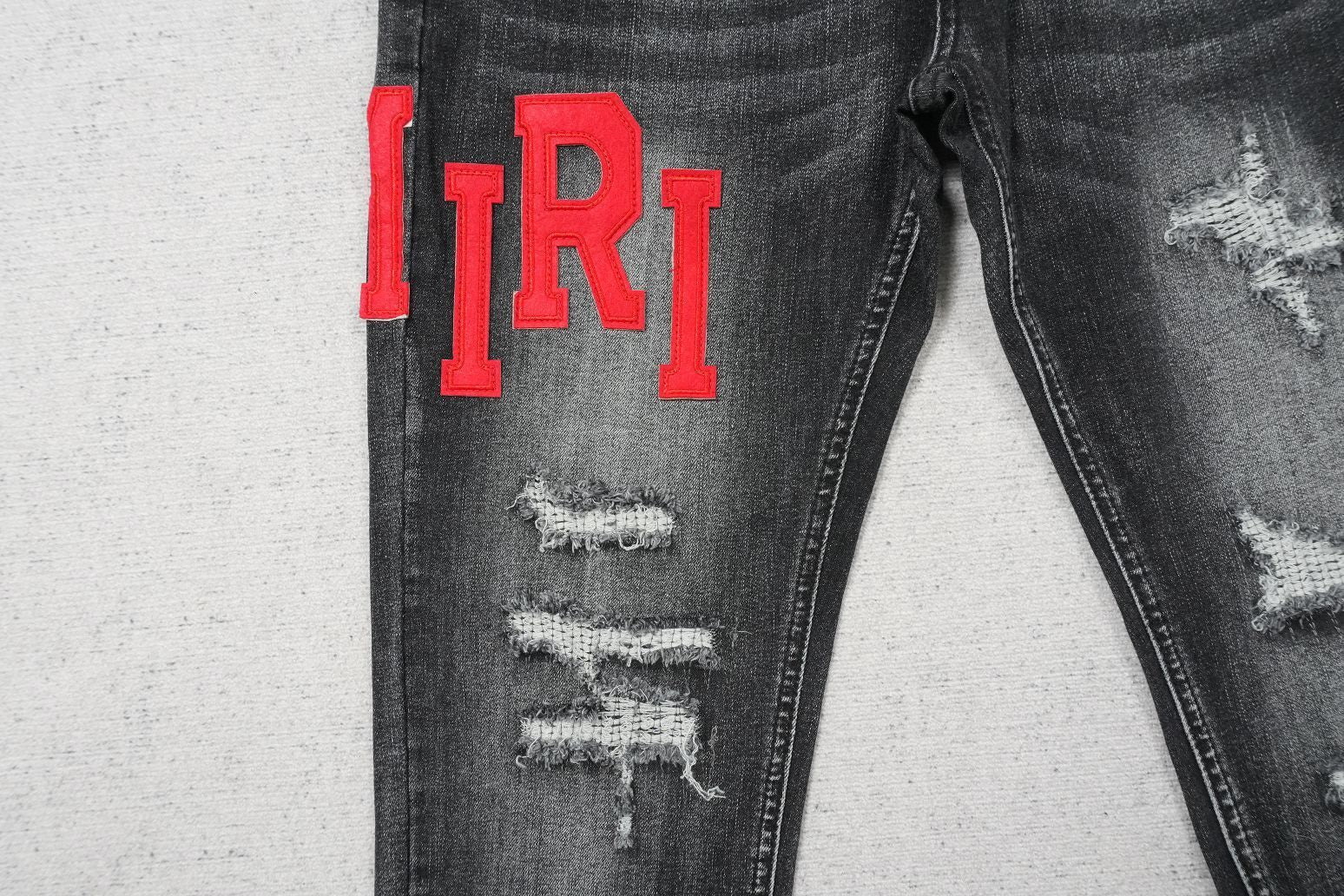 AMIRI BLACK WITH RED WRITTING